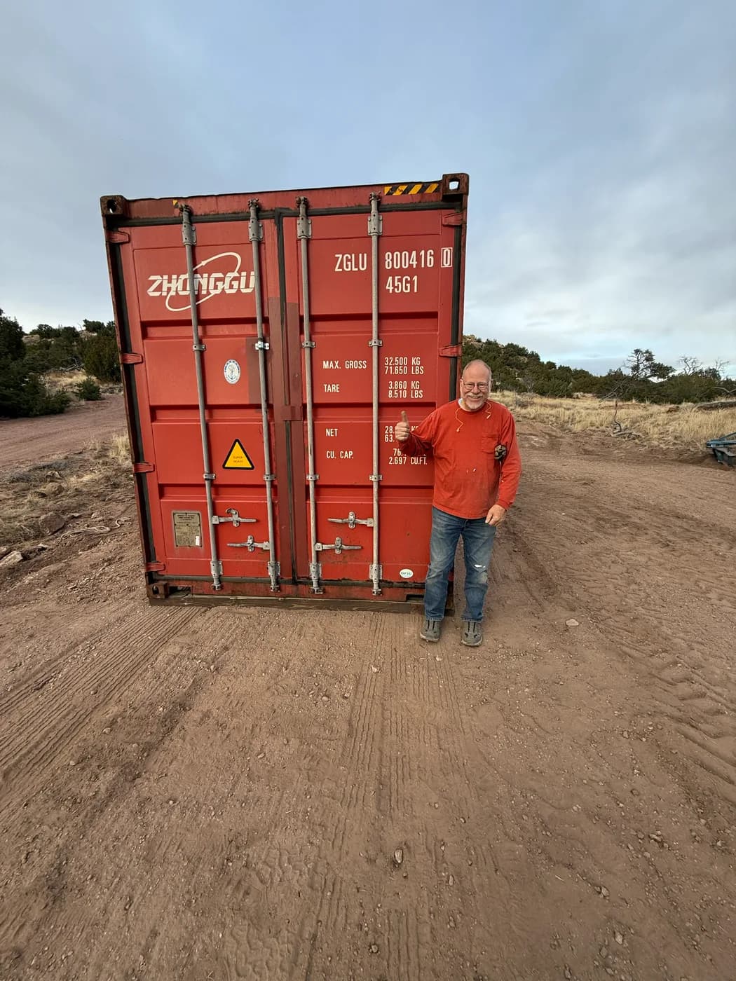 Red shipping container delivered in a field
