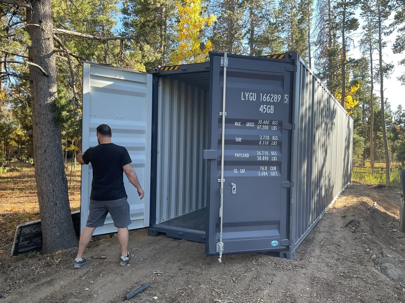Shipping container delivered in a wooded lot