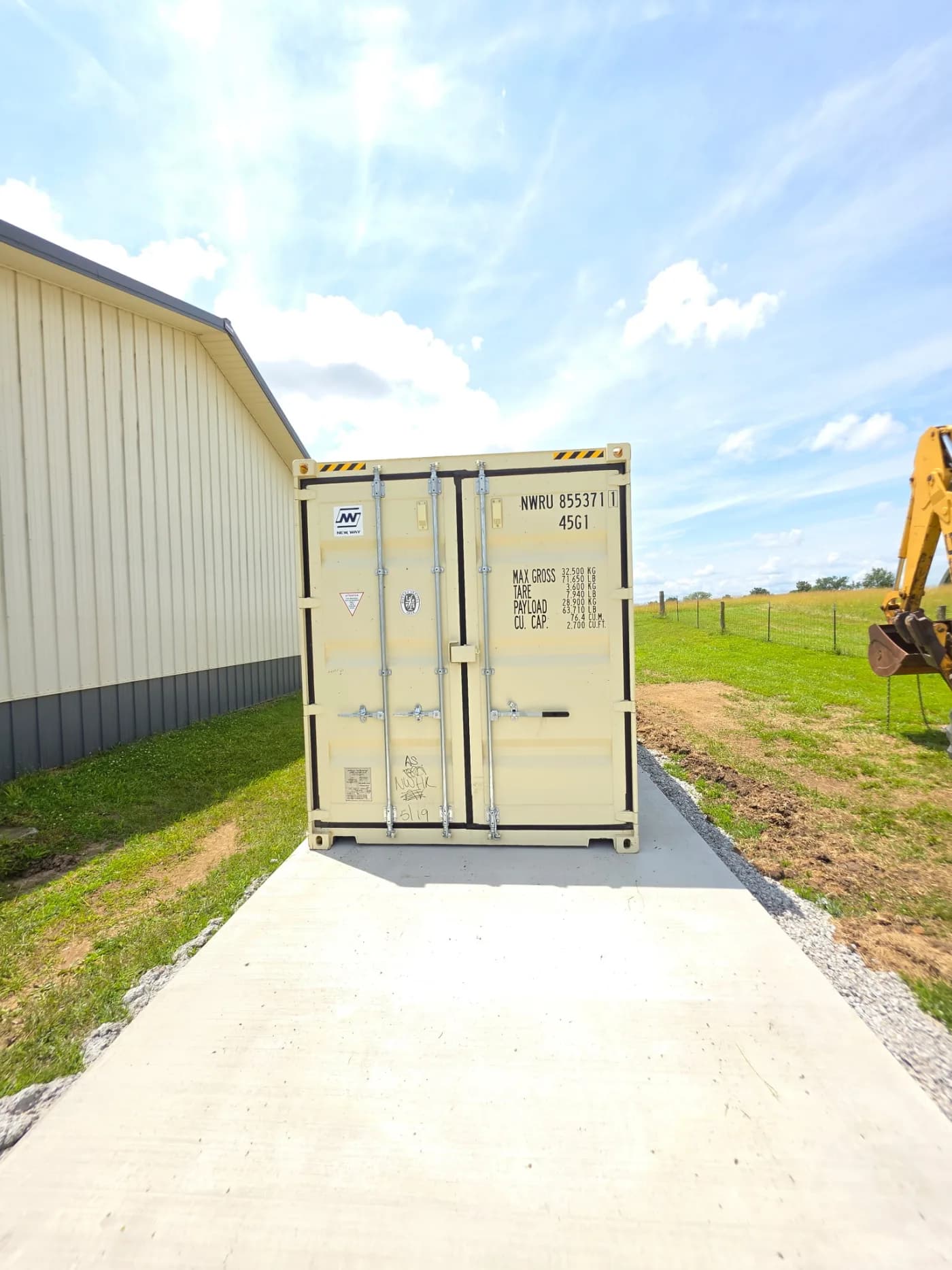 Shipping container delivered onto a concrete pad