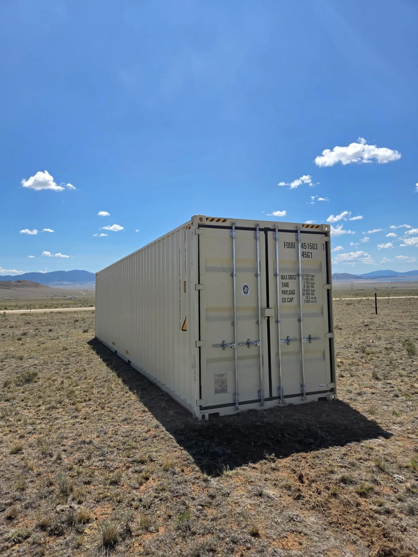 Shipping container placed directly on the ground in a field